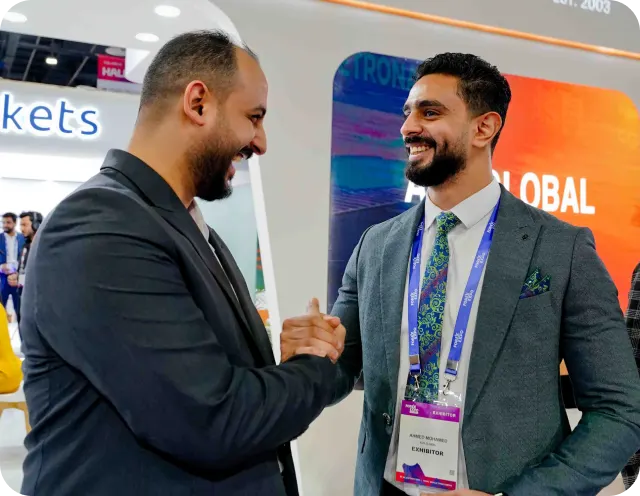 Traders and exhibitors talking at a Forex Expo booth