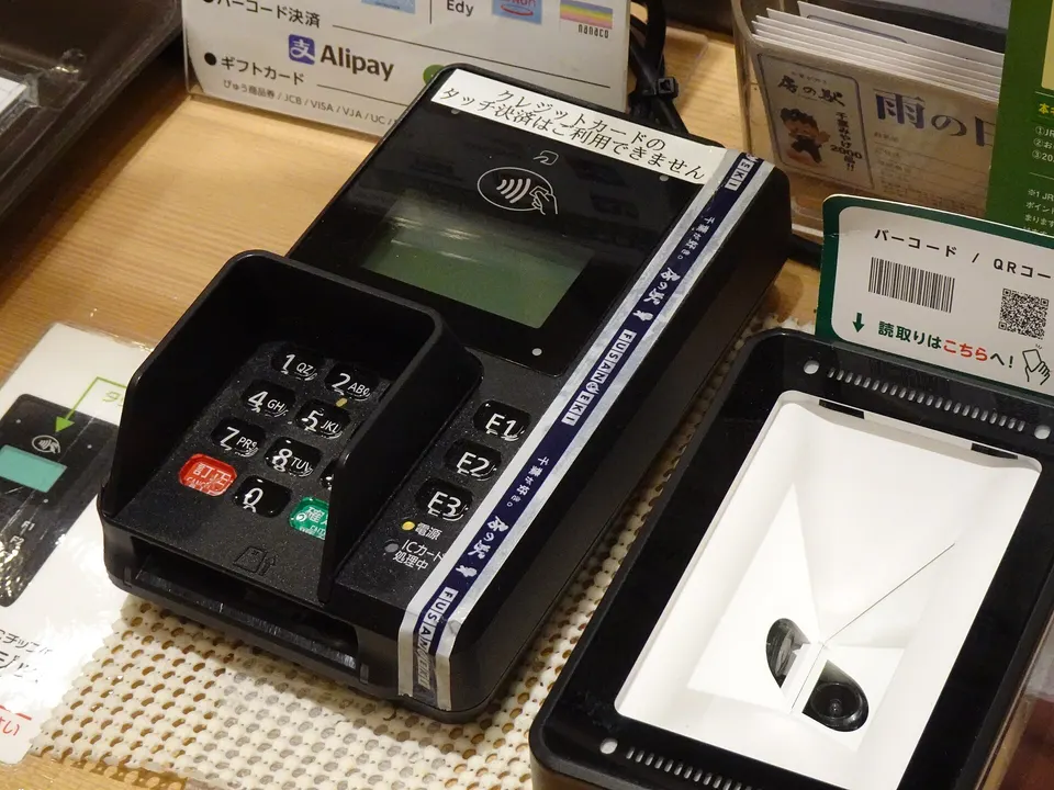 A shopper paying with a card at a terminal
