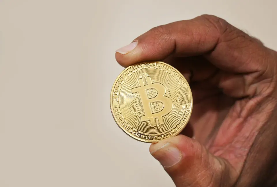 Bitcoin coin held in hand